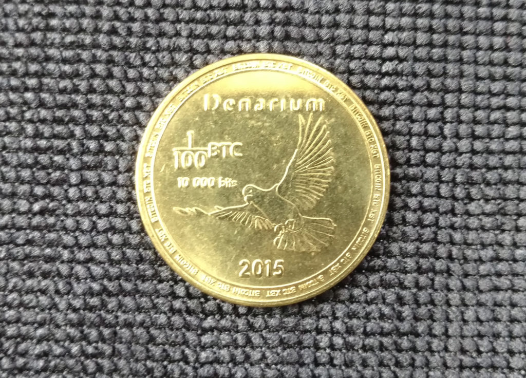 1/100 BTC brass Denarium coin.