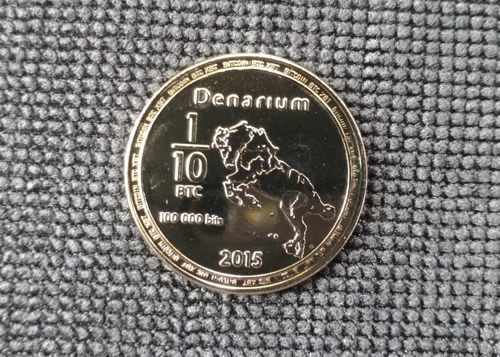 Denarium gold-plated 1/10 BTC piece, featuring scary horse.