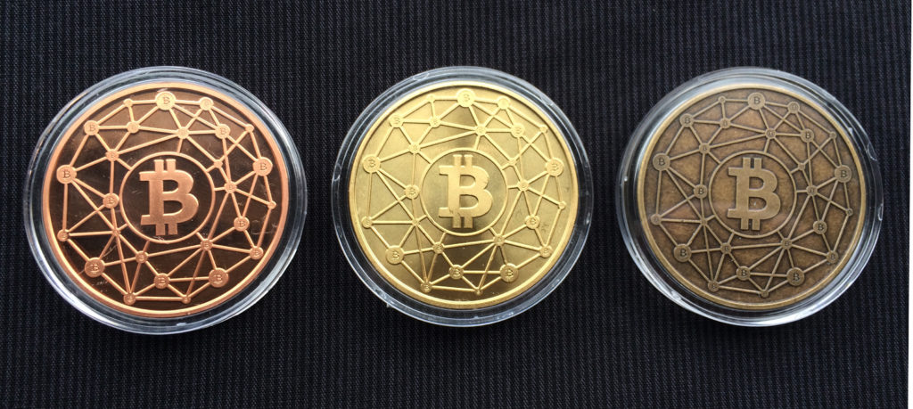 Cryptopods "Ravenbit Podified" coins in copper, brass and bronze, obverse.